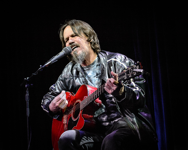 Vernon Webb playing acoustic guitar and singing